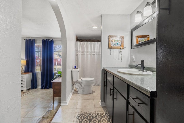 bathroom with vanity, tile patterned flooring, and toilet