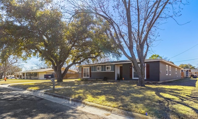 ranch-style home with a front lawn