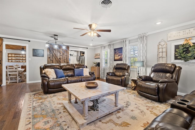 living room featuring crown molding, a barn door, and ceiling fan