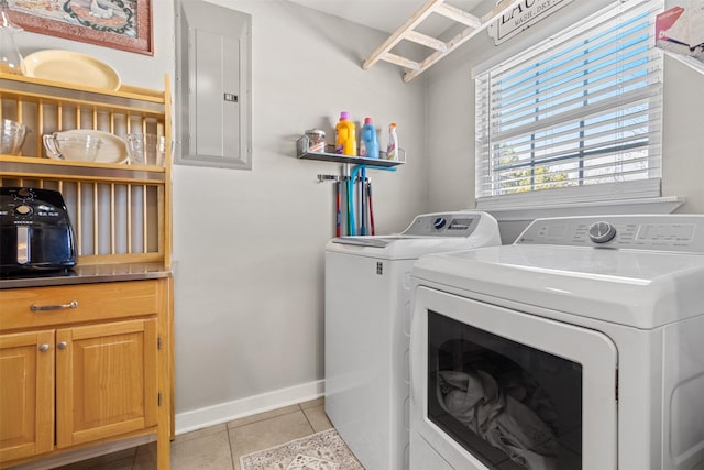 laundry area featuring cabinets, light tile patterned flooring, separate washer and dryer, and electric panel