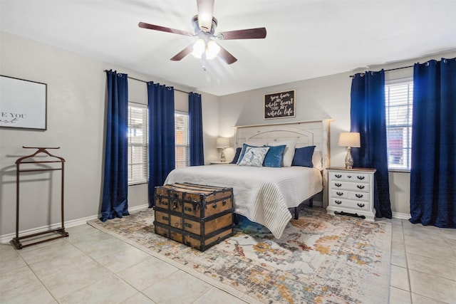 tiled bedroom featuring ceiling fan