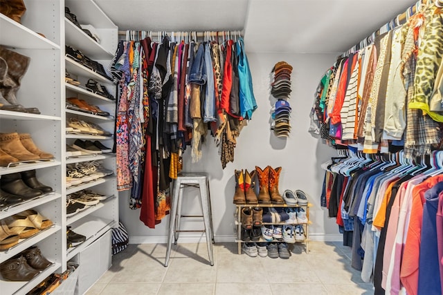 walk in closet with light tile patterned floors