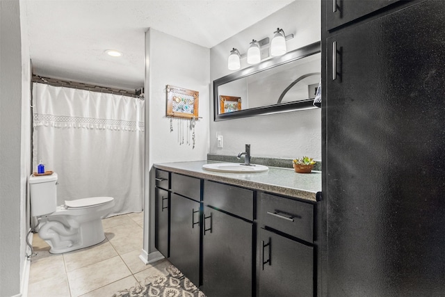 bathroom featuring tile patterned floors, toilet, and vanity