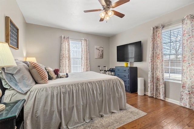 bedroom with ceiling fan and dark hardwood / wood-style floors