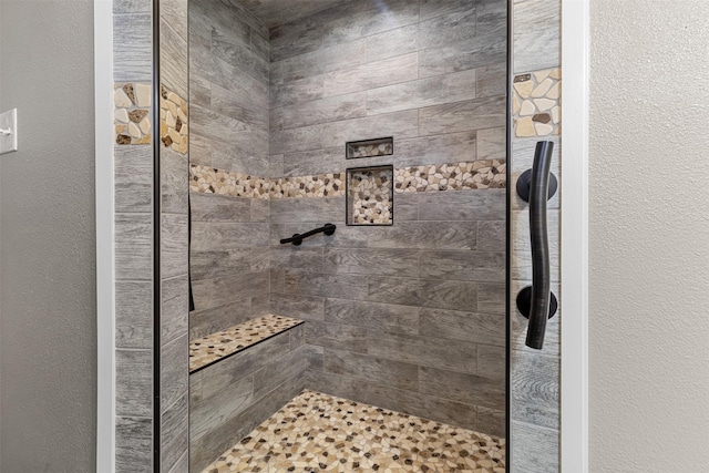 bathroom with a tile shower