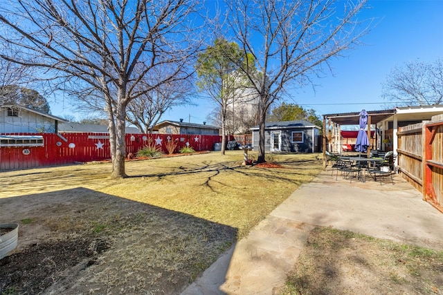 view of yard with an outdoor structure and a patio