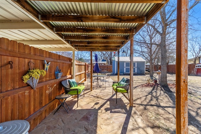 view of patio featuring a storage unit