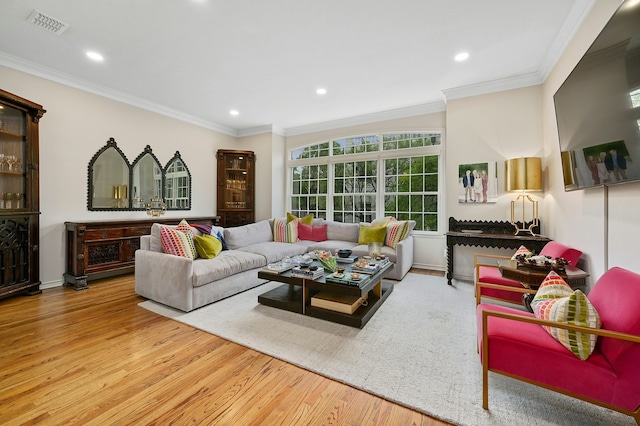 living room with hardwood / wood-style flooring and crown molding