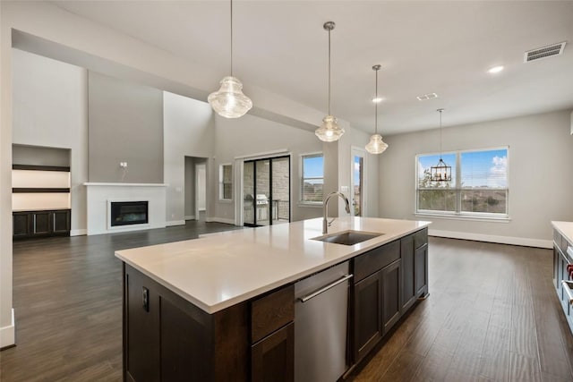 5801 Davenport Divide Rd, Austin, TX 78738 - kitchen with a sink, dishwasher, light countertops, dark wood-type flooring, and recessed lighting