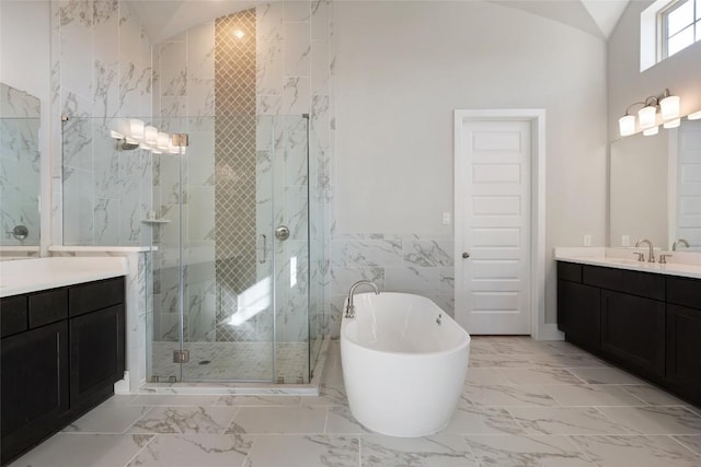 5801 Davenport Divide Rd, Austin, TX 78738 - bathroom with marble finish floors, a stall shower, vanity, a freestanding tub, and tile walls