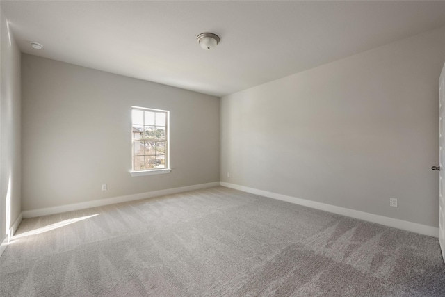 unfurnished room featuring light colored carpet