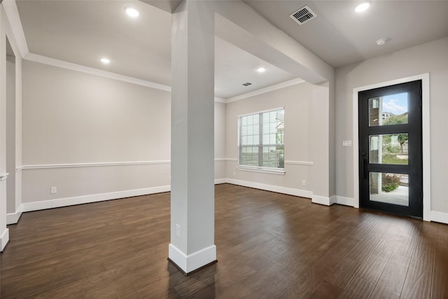 foyer with ornamental molding and dark wood-type flooring