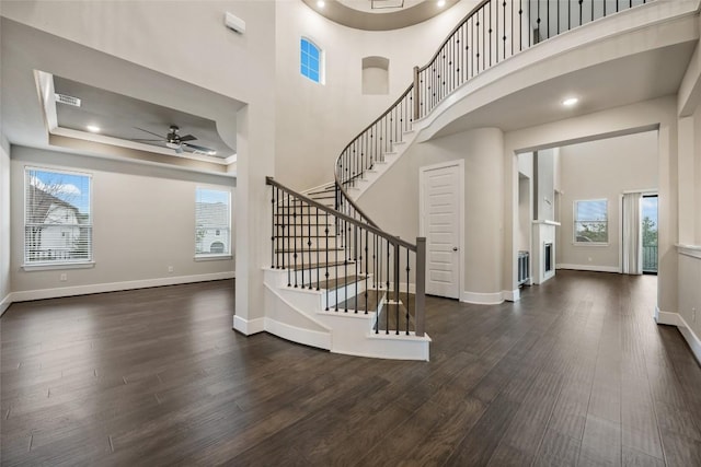 5801 Davenport Divide Rd, Austin, TX 78738 - entrance foyer with a ceiling fan, dark wood-style floors, stairs, a tray ceiling, and recessed lighting