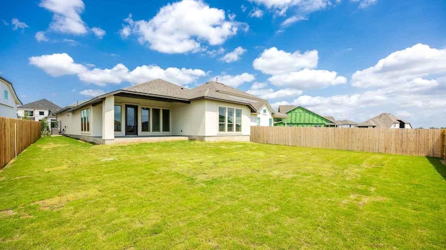 128 La Venta Loop, Liberty Hill, TX 78642 - back of house featuring a fenced backyard and stucco siding