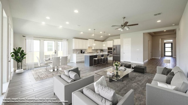 128 La Venta Loop, Liberty Hill, TX 78642 - living area featuring light wood-type flooring, vaulted ceiling, a ceiling fan, and recessed lighting