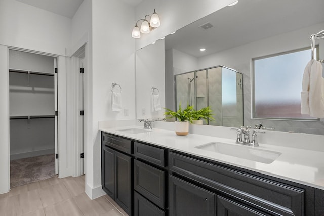 bathroom with an enclosed shower and vanity