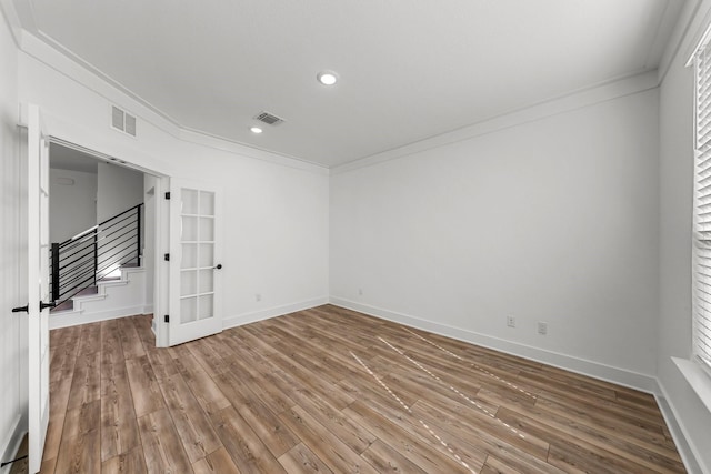 unfurnished room featuring crown molding and wood-type flooring