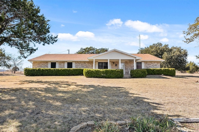 single story home with a porch and a front yard