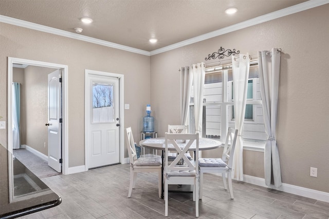 dining area with ornamental molding and a wealth of natural light