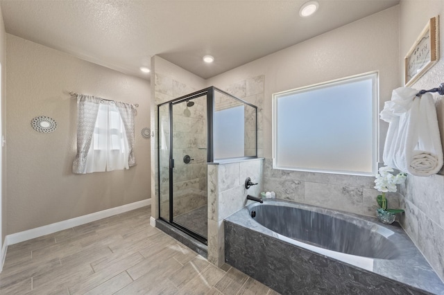 bathroom featuring independent shower and bath