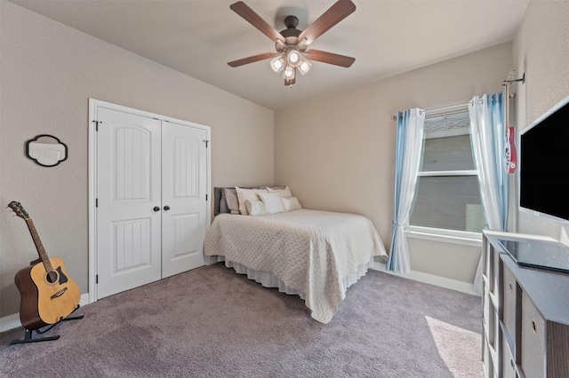 carpeted bedroom featuring ceiling fan and a closet