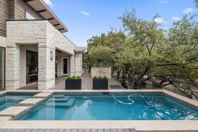 view of swimming pool with a deck