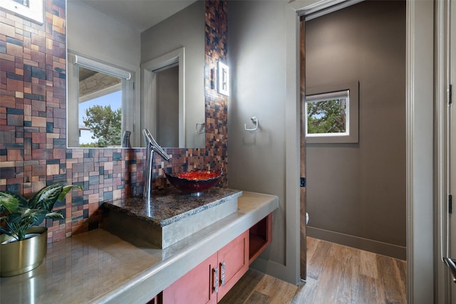 bathroom featuring tasteful backsplash, vanity, hardwood / wood-style floors, and toilet