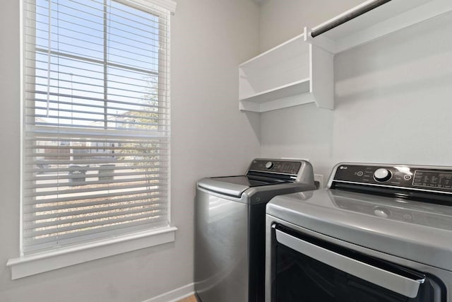 laundry area featuring washing machine and dryer and a healthy amount of sunlight