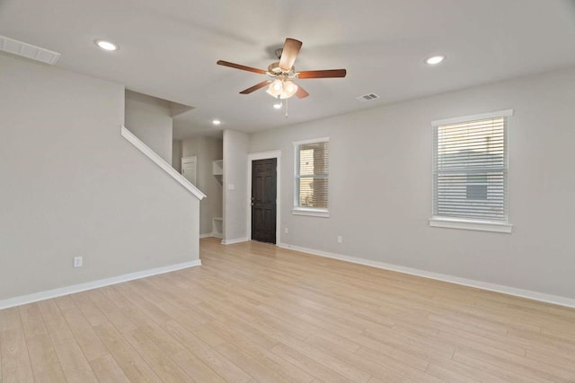 spare room featuring light hardwood / wood-style floors and ceiling fan