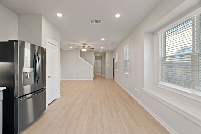 kitchen with ceiling fan, stainless steel fridge, and light hardwood / wood-style floors