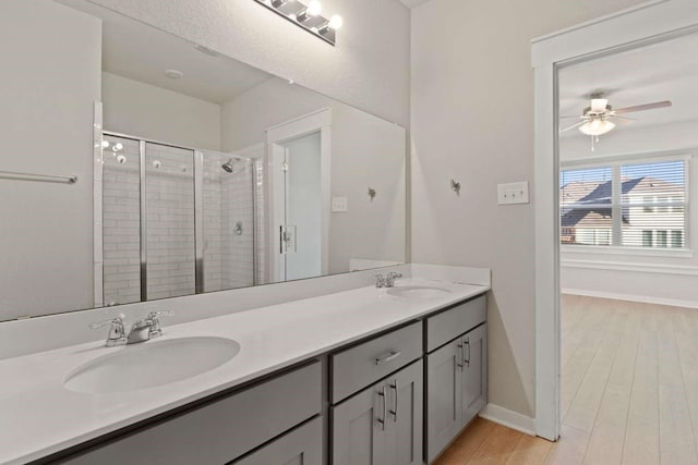 bathroom featuring vanity, hardwood / wood-style floors, ceiling fan, and walk in shower