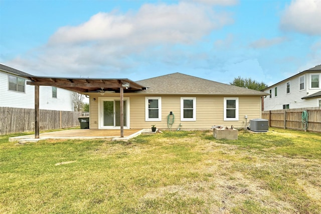 back of house with cooling unit, a yard, and a patio area