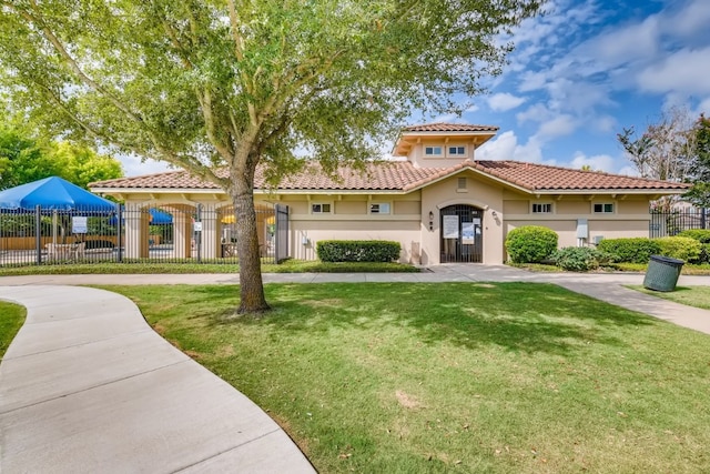 mediterranean / spanish house with a front lawn