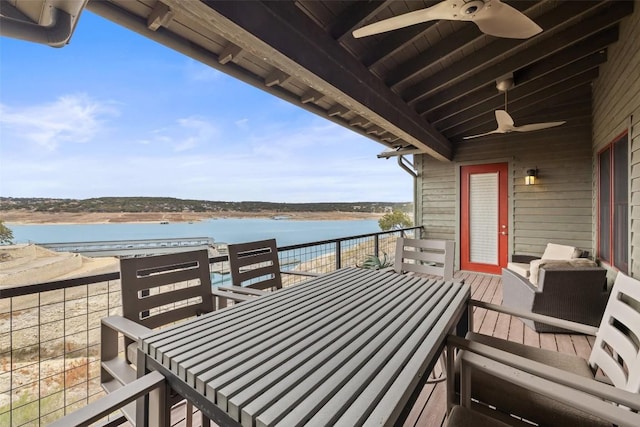 balcony featuring ceiling fan and a water view