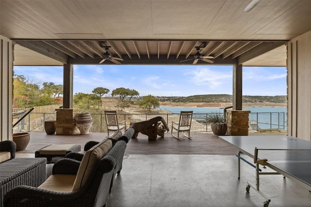 view of patio / terrace with ceiling fan and a water view