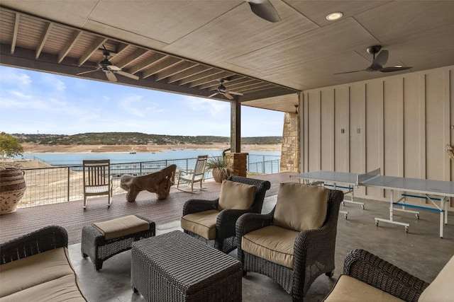 view of patio / terrace featuring a water view, outdoor lounge area, and ceiling fan