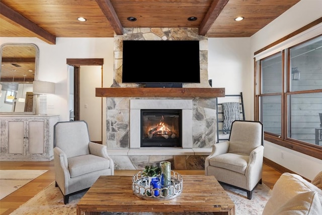 living room with light wood-type flooring, wooden ceiling, and a fireplace