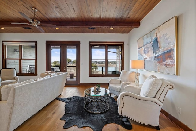 living room featuring french doors, light hardwood / wood-style flooring, wooden ceiling, ceiling fan, and beam ceiling