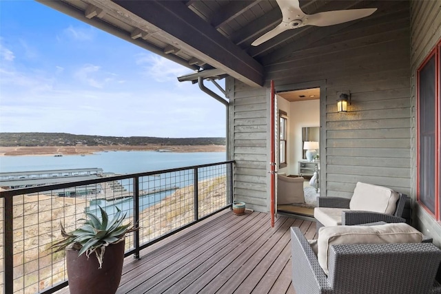 balcony featuring ceiling fan and a water view