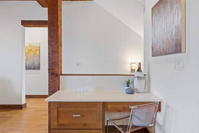 home office featuring built in desk and light hardwood / wood-style floors