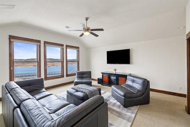 carpeted living room with vaulted ceiling, a water view, and ceiling fan