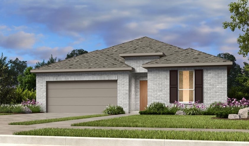 view of front facade with a garage and a front yard