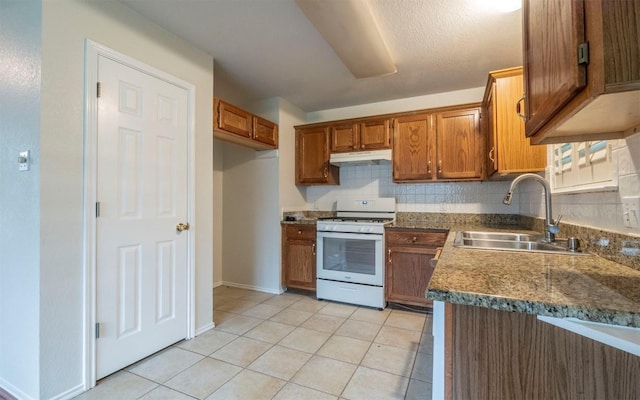 kitchen with light tile patterned flooring, sink, decorative backsplash, and gas range gas stove