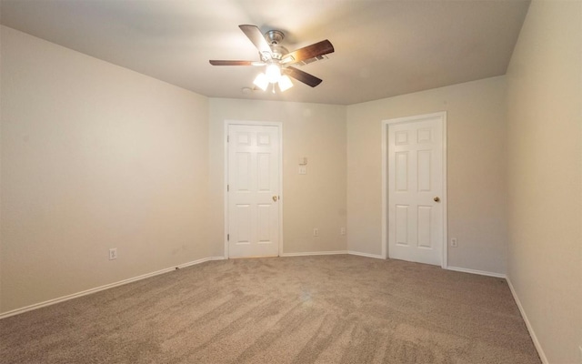 spare room with carpet floors and ceiling fan