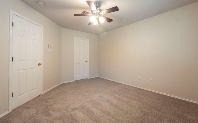 carpeted empty room with ceiling fan