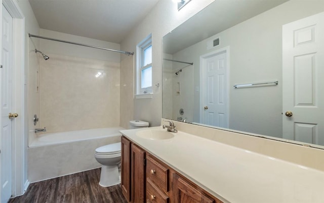 full bathroom with vanity, hardwood / wood-style flooring, tub / shower combination, and toilet