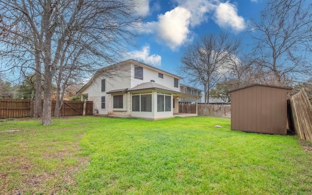 rear view of property featuring a storage shed and a lawn