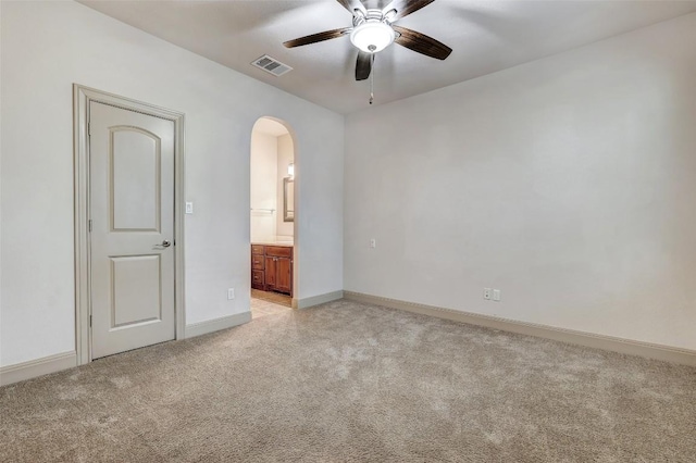 empty room featuring ceiling fan and light carpet