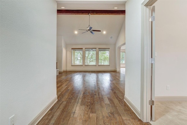 unfurnished living room with ceiling fan, beam ceiling, high vaulted ceiling, and hardwood / wood-style floors