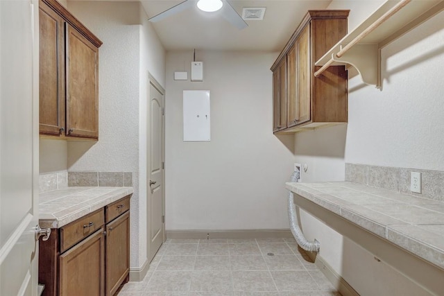 laundry area featuring cabinets